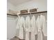 Well-organized closet featuring built-in shelving and hanging space with several plush robes at 25109 N 174Th Ln, Surprise, AZ 85387