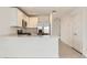Modern kitchen with stainless steel appliances, white cabinetry, and breakfast bar open to the living area at 25109 N 174Th Ln, Surprise, AZ 85387