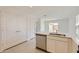 Kitchen featuring stainless steel dishwasher, bright white cabinets, and breakfast bar at 25109 N 174Th Ln, Surprise, AZ 85387