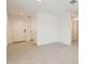 Spacious living area features neutral tile flooring and paint, with multiple access doors at 25109 N 174Th Ln, Surprise, AZ 85387