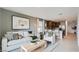 Open living area with a comfortable sofa, modern decor, and seamless flow to the kitchen at 25109 N 174Th Ln, Surprise, AZ 85387