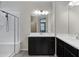 Bathroom featuring dual vanities, and glass enclosed shower at 29402 W Mitchell Ave, Buckeye, AZ 85396