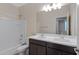 Bathroom with double vanity, tub/shower combination, and framed mirror at 29402 W Mitchell Ave, Buckeye, AZ 85396