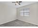 Comfortable bedroom with plush carpeting, ceiling fan, and bright window at 29402 W Mitchell Ave, Buckeye, AZ 85396
