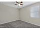 Neutral bedroom with a ceiling fan and large window at 29402 W Mitchell Ave, Buckeye, AZ 85396
