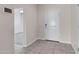Bright foyer with tile flooring, neutral walls, and a doorway leading to a carpeted room at 29402 W Mitchell Ave, Buckeye, AZ 85396