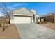 Inviting single-Gathering home with a concrete driveway, two-car garage, and desert landscaping at 29402 W Mitchell Ave, Buckeye, AZ 85396