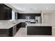 Updated kitchen boasting stainless steel appliances, a center island, and granite countertops at 29402 W Mitchell Ave, Buckeye, AZ 85396