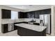 Stylish kitchen with granite countertops, dark wood cabinets, and stainless steel appliances at 29402 W Mitchell Ave, Buckeye, AZ 85396