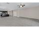 Open-concept living room features tile flooring, a ceiling fan, and kitchen access at 29402 W Mitchell Ave, Buckeye, AZ 85396