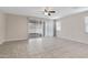 Spacious living room with tile floors, ceiling fan, and sliding glass door at 29402 W Mitchell Ave, Buckeye, AZ 85396