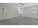 Bright main bedroom with neutral walls, carpeted floors, and ensuite access at 29402 W Mitchell Ave, Buckeye, AZ 85396
