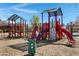 Community playground featuring multiple colorful slides and climbing structures for to play and explore at 29402 W Mitchell Ave, Buckeye, AZ 85396