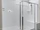 Walk-in shower featuring glass door, seating, and shower head at 29402 W Mitchell Ave, Buckeye, AZ 85396