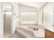 Bright bathroom featuring a garden tub, natural light, and a separate shower at 3337 E Glade Cir, Mesa, AZ 85204