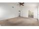 Spacious bedroom featuring neutral walls and carpet, ceiling fan, and doors to the second story at 3337 E Glade Cir, Mesa, AZ 85204