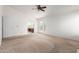 Spacious bedroom featuring neutral walls and carpet, ceiling fan, and doors to the outside and the bathroom at 3337 E Glade Cir, Mesa, AZ 85204