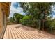 Open-air wooden deck with black metal railings overlooking trees and the backyard at 3337 E Glade Cir, Mesa, AZ 85204