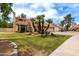 Charming two-story home features a red tile roof, two-car garage and mature palm trees at 3337 E Glade Cir, Mesa, AZ 85204