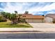 Charming two-story home features a red tile roof, three-car garage and mature palm trees at 3337 E Glade Cir, Mesa, AZ 85204