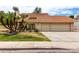 Charming two-story home features a red tile roof, three-car garage and mature palm trees at 3337 E Glade Cir, Mesa, AZ 85204