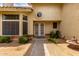 The charming front entrance features a decorative door, bay window, and desert landscaping at 3337 E Glade Cir, Mesa, AZ 85204