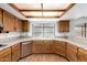 Kitchen with wood cabinets, stainless steel appliances, and lots of natural light at 3337 E Glade Cir, Mesa, AZ 85204