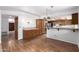 Bright kitchen with breakfast bar, tile countertops, wood cabinets, and stainless steel appliances at 3337 E Glade Cir, Mesa, AZ 85204