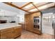 Open floor plan kitchen with wood cabinets, double oven, tile counter and view to living room at 3337 E Glade Cir, Mesa, AZ 85204