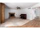 Living room featuring a brick fireplace, ceiling fan, and a vintage piano at 3337 E Glade Cir, Mesa, AZ 85204