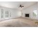 Large living room with neutral walls, fireplace, ceiling fan, and windows at 3337 E Glade Cir, Mesa, AZ 85204