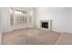 Spacious living room with vaulted ceilings, fireplace, neutral carpet and updated windows at 3337 E Glade Cir, Mesa, AZ 85204