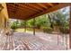 Spacious covered patio featuring brick flooring and overlooks the green backyard at 3337 E Glade Cir, Mesa, AZ 85204