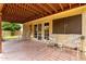 Inviting covered patio with brick flooring and open access to a well-maintained lawn at 3337 E Glade Cir, Mesa, AZ 85204