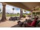 This charming back patio features a tranquil water feature, comfortable seating, and views of the golf course at 3441 N 162Nd Ln, Goodyear, AZ 85395