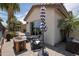 The private backyard boasts a fire pit, seating, and access to the covered patio and lush greenery at 3441 N 162Nd Ln, Goodyear, AZ 85395