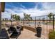 Inviting backyard with ample seating, a fire pit, and beautiful views of the lake and golf course at 3441 N 162Nd Ln, Goodyear, AZ 85395