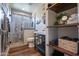 Stylish bathroom featuring modern fixtures, a tiled shower, and open shelving with decor at 3441 N 162Nd Ln, Goodyear, AZ 85395
