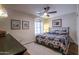 Cozy bedroom featuring a ceiling fan, southwestern themed bedding, and plantation shutters at 3441 N 162Nd Ln, Goodyear, AZ 85395