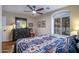 Bedroom highlighting southwest themed bedding, a ceiling fan, and large window with shutters at 3441 N 162Nd Ln, Goodyear, AZ 85395