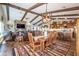 Open concept living and dining area with vaulted ceilings and wood beam accents provides a cozy and inviting atmosphere at 3441 N 162Nd Ln, Goodyear, AZ 85395