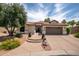 Charming single-story home featuring a tile roof, manicured landscaping, and a two-car garage at 3441 N 162Nd Ln, Goodyear, AZ 85395