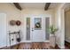 Elegant foyer with hardwood floors, decorative accents, and a bright white front door at 3441 N 162Nd Ln, Goodyear, AZ 85395