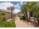Charming front yard featuring desert landscaping, palm trees, a walkway, and an American flag at 3441 N 162Nd Ln, Goodyear, AZ 85395