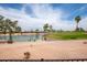 Scenic view of a golf course and a pond under a blue sky with fluffy clouds at 3441 N 162Nd Ln, Goodyear, AZ 85395