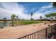 Scenic view of a golf course and a pond under a blue sky with fluffy clouds at 3441 N 162Nd Ln, Goodyear, AZ 85395