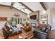 Open living room boasts a stone fireplace, wood beams, and leather furnishings at 3441 N 162Nd Ln, Goodyear, AZ 85395