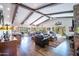 Spacious living room featuring beamed ceilings, hardwood floors, and ample natural light at 3441 N 162Nd Ln, Goodyear, AZ 85395