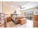 Spacious main bedroom with wood furniture, ceiling fan and access to outdoor deck with pond views provides a luxurious retreat at 3441 N 162Nd Ln, Goodyear, AZ 85395