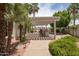 Outdoor kitchen and dining area featuring a pergola, bar seating, and landscaped surroundings at 3441 N 162Nd Ln, Goodyear, AZ 85395